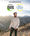 Man wearing Men's UPF 50+ ProtectUV Mega Solar Long Sleeve Shirt hiking in mountains with Melanoma Foundation Seal visible