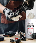 Heavy Duty Gun Cleaning Wipes Pack 120 Wipes 5x7 Inch CLP Gun Cleaner Lubricant Clean Lubricate Protect For Field And Range NATO O 190 MIL PRF 32033 On The Go Clean As A Whistle container next to firearm being cleaned with wipe