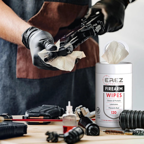 Heavy Duty Gun Cleaning Wipes Pack 120 Wipes 5x7 Inch CLP Gun Cleaner Lubricant Clean Lubricate Protect For Field And Range NATO O 190 MIL PRF 32033 On The Go Clean As A Whistle container next to firearm being cleaned with wipe