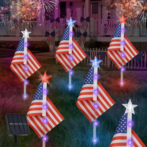 Six Pack 30 LED Solar Patriotic Pathway Lights With 6 US Flags And Flag Stakes Bright Red White And Blue Outdoor Yard Decor For Fourth Of July Memorial Day Lawn Garden, showing lit flags with fireworks