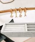 Keep Your Daily Bling Neatly Stashed In This Slick Gray Velvet Jewelry Organizer Tray With Elastic Grid For Rings Earrings Necklaces Watches Glasses Totally Solid For Home Or Store Display with gold letter earrings displayed.