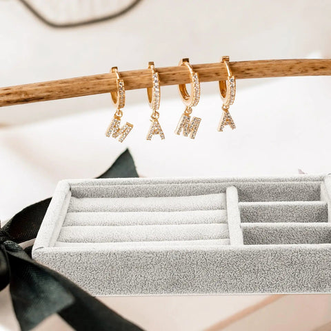 Keep Your Daily Bling Neatly Stashed In This Slick Gray Velvet Jewelry Organizer Tray With Elastic Grid For Rings Earrings Necklaces Watches Glasses Totally Solid For Home Or Store Display with gold letter earrings displayed.