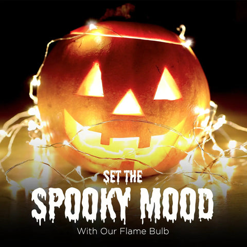 Jack-o'-lantern decorated with string lights and Orange LED Lit Flame Bulbs With Four Modes Indoor Outdoor Use 3W E26 E27 2 Pack