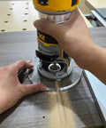 Legit 6 Inch Round Clear Acrylic Router Base Plate Upgrade Featuring Pre Drilled Alignment Holes For DWP611 DCW600B Compact Routers used in woodworking.
