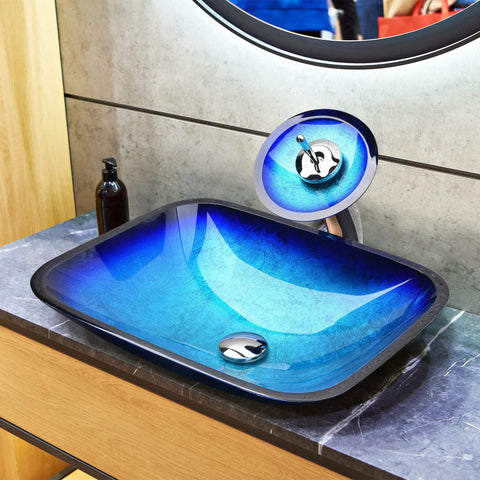 Dope Blue Ripple Tempered Glass Vessel Sink With Waterfall Faucet For Above Counter Vanity Rectangle Design Pop Up Drain Victorian Era Inspired Look For Modern Bathrooms, shown on vanity with faucet running.