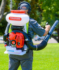 Man using a motorized fertilizer spreader broadcast 4 gallon capacity for lawn care, seed distribution, and ice melt salt, 30 ft reach.