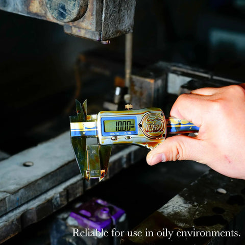 Hand holding IP67 Waterproof Digital Vernier Caliper Stainless Steel Absolute Origin Measuring Tool in an industrial setting.
