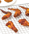 Chicken wings on a Two Pack Stainless Steel Cooling Rack For Baking 16x10 Inches, Oven Safe Thick Wire Cookie Rack, Silver