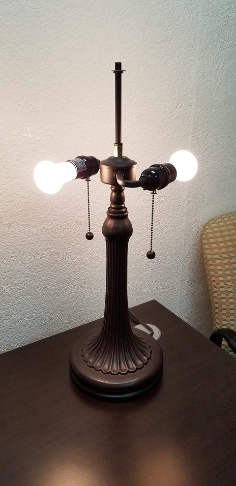 Base of Tiffany Style Table Lamp With Floral Banker Design, without shade, showing dual pull chains on a tabletop.