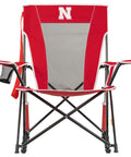 Front view of Comfort Pro Rocker Camping Chair With Drink Holder, featuring Nebraska Cornhuskers logo, sturdy armrests, and red design.