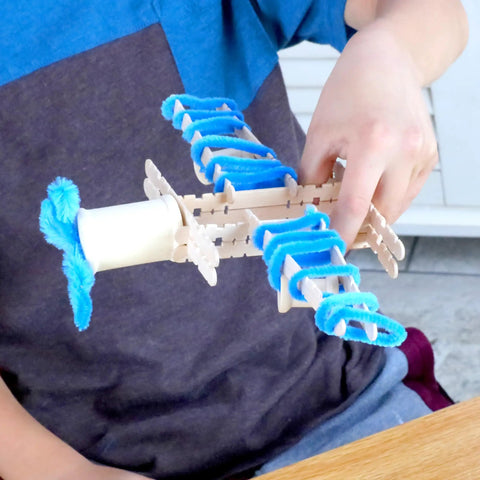 Child creating toy airplane with DIY Arts And Crafts Starter Kit Mega Box With Pounds Of Craft Supplies For Kids Ages Four Through Twelve