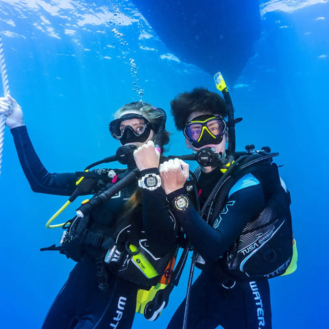 Divers underwater wearing Liberator BCD With AWLS III and RiteTite Harness for boss level tank stability in deep dive setting.