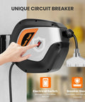 Close-up of a hand pressing switch on Heavy Duty Retractable Extension Cord Reel With Lit Triple Tap, wall-mounted in garage.