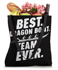 Black tote bag with 'Best Dragon Boat Team Ever' text, filled with flowers, bread, and bananas. Paddler Tote Bag For Dragon Boat Racing And Dragonboating Enthusiasts Dope Gear For Synchronous Paddling Teams Festival Ready Durable Dragon Boat Team Tote For Men And Women Perfect Gift For Dragon Boat Fans.