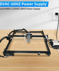 Air assist pump kit for laser cutter on a black aluminum frame with white tubing and power supply (front view)