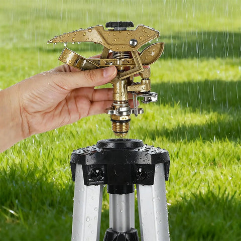 Heavy Duty Tripod Sprinkler Head Kit With 360 Degree Coverage For Lawn And Garden Yard Friendly Zinc Alloy Irrigation Head Three Quarters Inch NH Connector Extendable Legs Rust Resistant 2 Pack being adjusted by hand in a garden