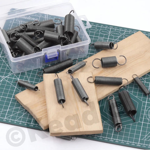 Heavy Duty Extension Spring Kit 36 Pieces, 12 Sizes, zinc plated springs with hooks displayed on wooden boards and mat
