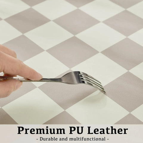 Close-up of fork testing durability on Large Checkered Desk Pad 31.5 Inch By 15.7 Inch Premium PU Leather Desk Mat Waterproof Surface