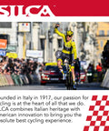 Cyclist finishing race with spectator crowd and SILCA branding in overhead archway