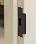 Close-up of Heavy Duty Lever Style Interior Door Lock Grade Two Commercial Passage Lock with oil rubbed bronze finish installed.