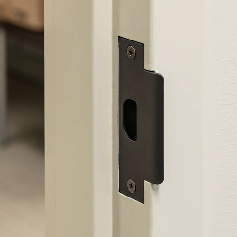 Close-up of Heavy Duty Lever Style Interior Door Lock Grade Two Commercial Passage Lock with oil rubbed bronze finish installed.