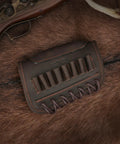 Adjustable Cheek Riser Rifle Stock Pad with Leather Protection and Eight-Round Ammo Holder, placed on brown fur surface.