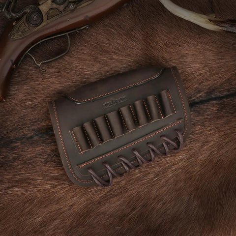 Adjustable Cheek Riser Rifle Stock Pad with Leather Protection and Eight-Round Ammo Holder, placed on brown fur surface.