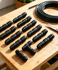 Get This Awesome 8 Pack Of 1/2 Inch Hose Connectors For Your Garden, Soaker Hoses, And Washing Machine! These Tough Molded Plastic Fittings Are Perfect For Quick Repairs, Fixing Leaks, And Extending Water Lines Anywhere Around Your Yard Or Home System. 8 black 1/2-inch plastic hose connectors on a table