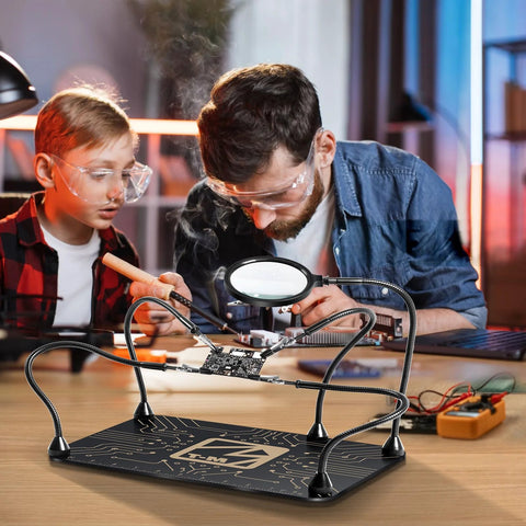 Front view: M-T Helping Hands soldering station with four flexible arms and 5x magnifier over PCB on a weighted base