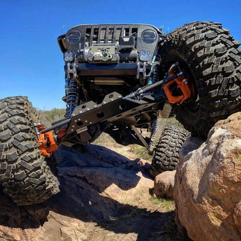 Heavy Duty Chromoly Half Inch Heim Joint Kit For Utvs Suspension And Rock Crawling Includes Right And Left Tie Rod Ends With Jam Nuts Plus One Inch Weld Bung Adapters For Badass Trail Builds on off-road vehicle climbing rocky terrain.