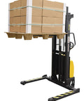 Rock Solid DC Powered Electric Pallet Stacker With Adjustable Forks And Leveling Legs Reaches Sixty Three Inch Lift Height Handles Two Thousand Pounds Smoothly Makes Heavy Loads Feel Light For Zero Stress Shop Jobs lifting stacked boxes on a pallet.