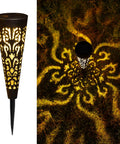 Solar Powered Fire Totem Style Outdoor Garden Light illuminating grass with patterns, waterproof conical stake for yard.