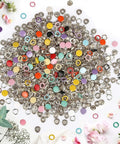 Assorted colorful and metallic snap buttons spread out, part of the Must Have Metal Snap Buttons Kit With Fastener Pliers Press Tool For DIY Crafts.
