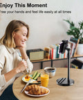 Woman using Telescopic Webcam Tripod Desk Mount With Phone Holder, Adjustable 11.4 To 18.7 Inches, at breakfast table