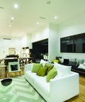 Living room with 4 Inch LED Gimbal Recessed Downlight 500 Lumen lighting, highlighting artwork and architectural accents