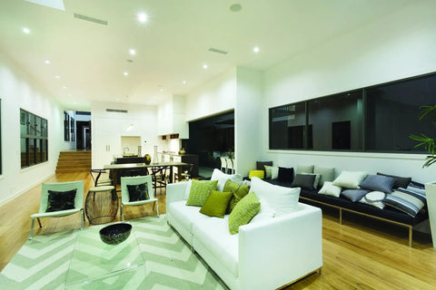 Living room with 4 Inch LED Gimbal Recessed Downlight 500 Lumen lighting, highlighting artwork and architectural accents