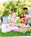 Family picnic with Portable Cold Water Dispenser For Office Desk Countertop With Tap next to a picnic basket on grass