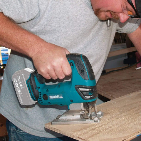 Man using Cordless Jig Saw 18V LXT Brushed Lithium-Ion, Variable Speed 0-2600 SPM, 3 Orbital Settings Plus Straight Cut on wood