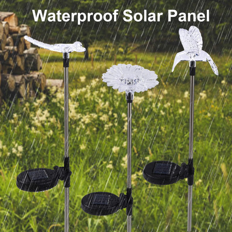 Six Pack Solar Garden Stake Lights With Color Changing LEDs featuring dragonfly and butterfly figurines in rain