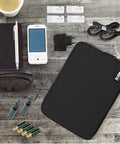 Double Layer Electronic Accessories Organizer Bag For Cables USB Drives And Gadgets Lightweight Travel Gadget Pouch With Padded Inner Compartments Fits iPad Mini And Other Small Tablets Black next to phone and notebook on table