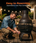 Man assembling a Chiminea Outdoor Fireplace Wood Burning Fire Pit for Backyard and Camping in Brown Black Finish on a deck