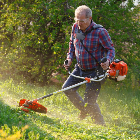 Man using a grass trimmer with 60 Pack String Trimmer Blades Replacement Set for Weed Eater Wacker Blades with Universal Fit, Red