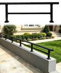 Boost Your Deck Safety Levels With This Heavy Duty Patio Railing Extension Designed For Raising Low Walls. Black steel railing on a low wall.