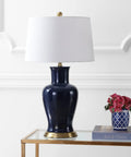 Navy Ceramic Urn LED Table Lamp, 29 Inch, Traditional Classic Style, White Linen Drum Shade on a glass table in living room