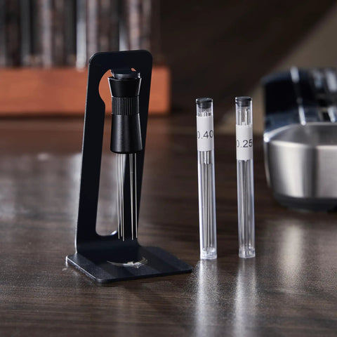 Killer 54Mm Bottomless Portafilter Set For Breville Espresso Machines showing calibrated tamper and dosing funnel tools on a countertop.
