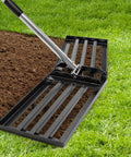 Angled Design Lawn Leveling Rake With 30 By 10 Inch Stainless Steel Head And 70 Inch Adjustable Handle on grass and soil