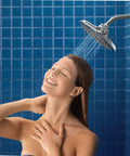 Woman enjoying shower under Velocity Chrome Two-Function Rain Shower Head With Immersion Technology, 8-Inch Wide Spray, Easy Install
