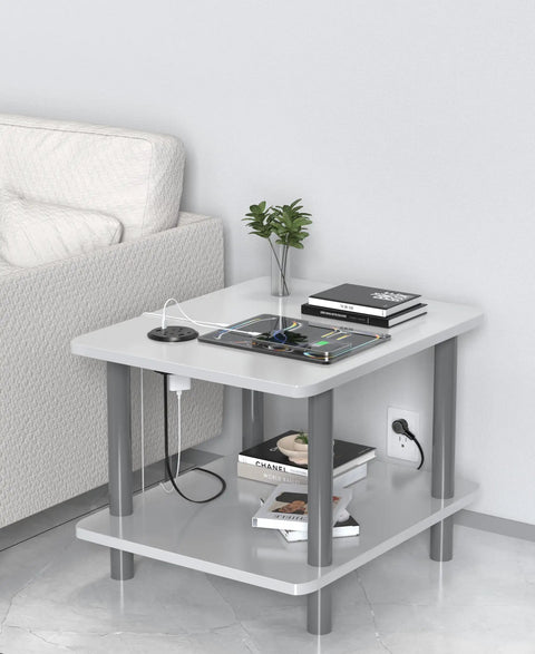 Sleek Flush Mount Power Grommet Featuring Four Standard Outlets And Four USB C Fast Charging Ports For Your Next Big Boss Setup And Countertop Organization Game Changer For Modern Home Office Black Dual Sided Design Six Foot Cord on a modern gray table with gadgets.