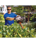 Man using 40V MAX Cordless Hedge Trimmer With 24 Inch Dual Action Blade, No Cords Needed, Long Battery Life, Includes Battery and Charger
