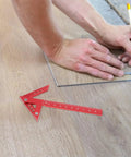 Dead On Aluminum Center Scriber Marking Gauge Wheel For Slick Woodworking Line Scribing And 45 Degree Angle Layouts In Professional Carpentry Workshops with red handle on wood flooring.
